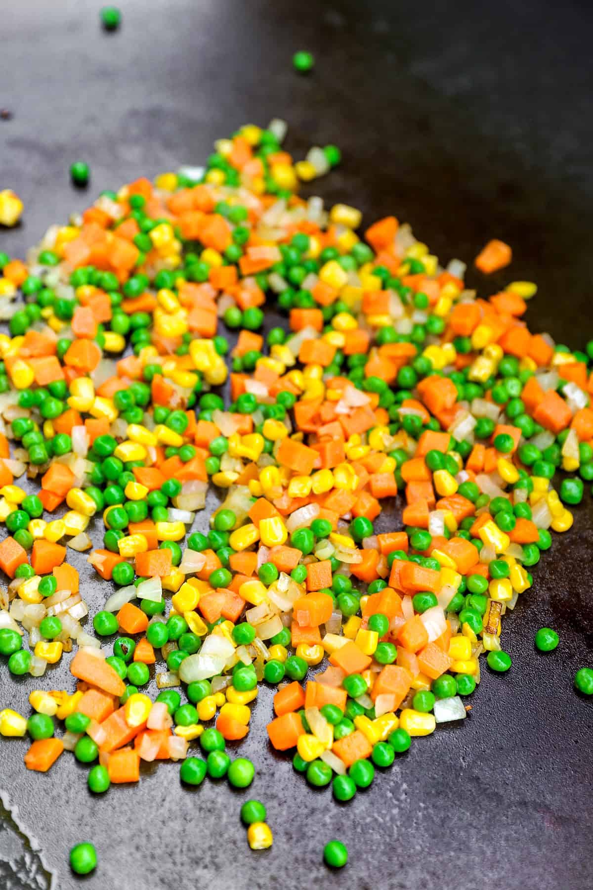 Frozen veggies in a skillet.