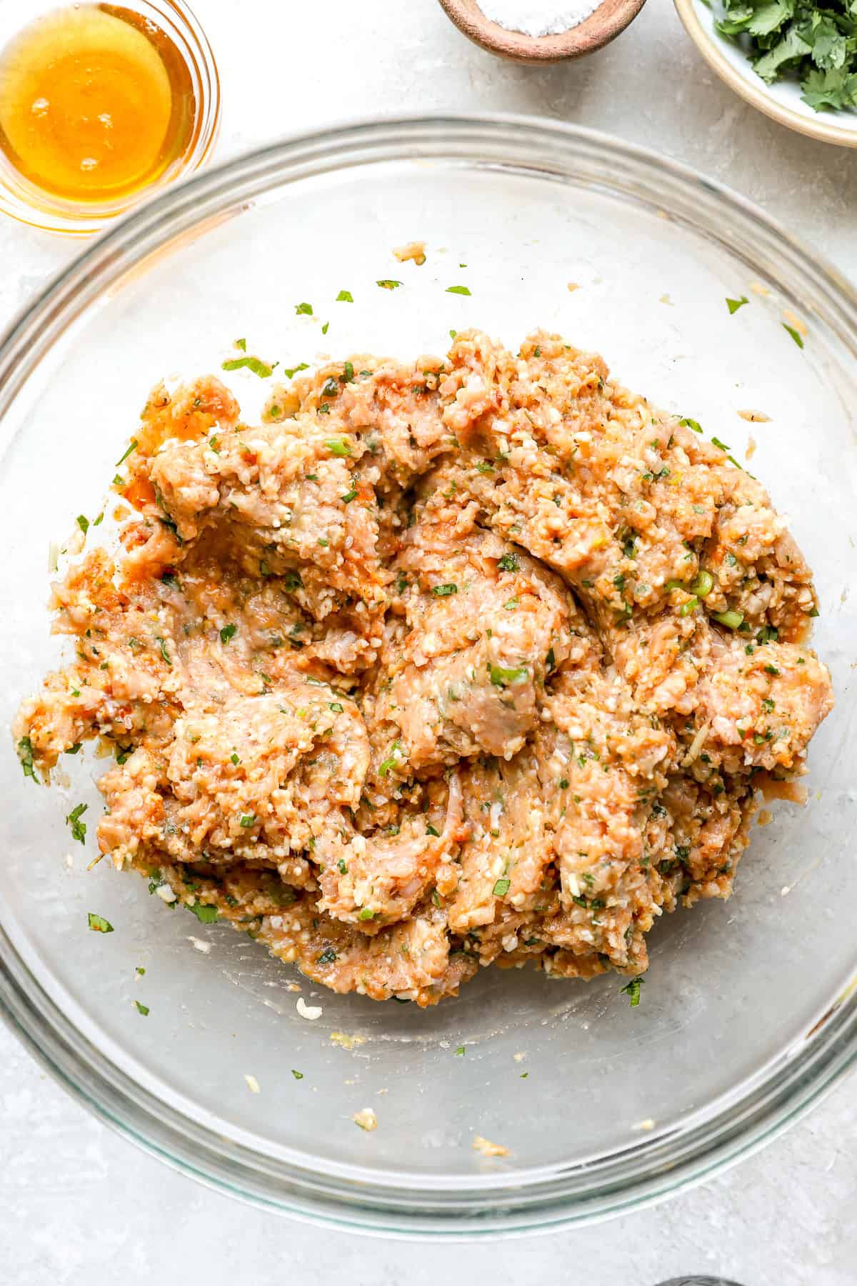 A honey garlic chicken meatball mixture in a bowl.
