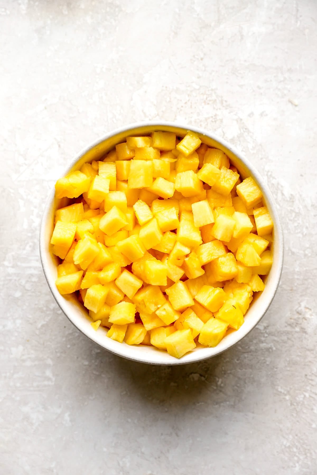 A bowl of diced pineapple.