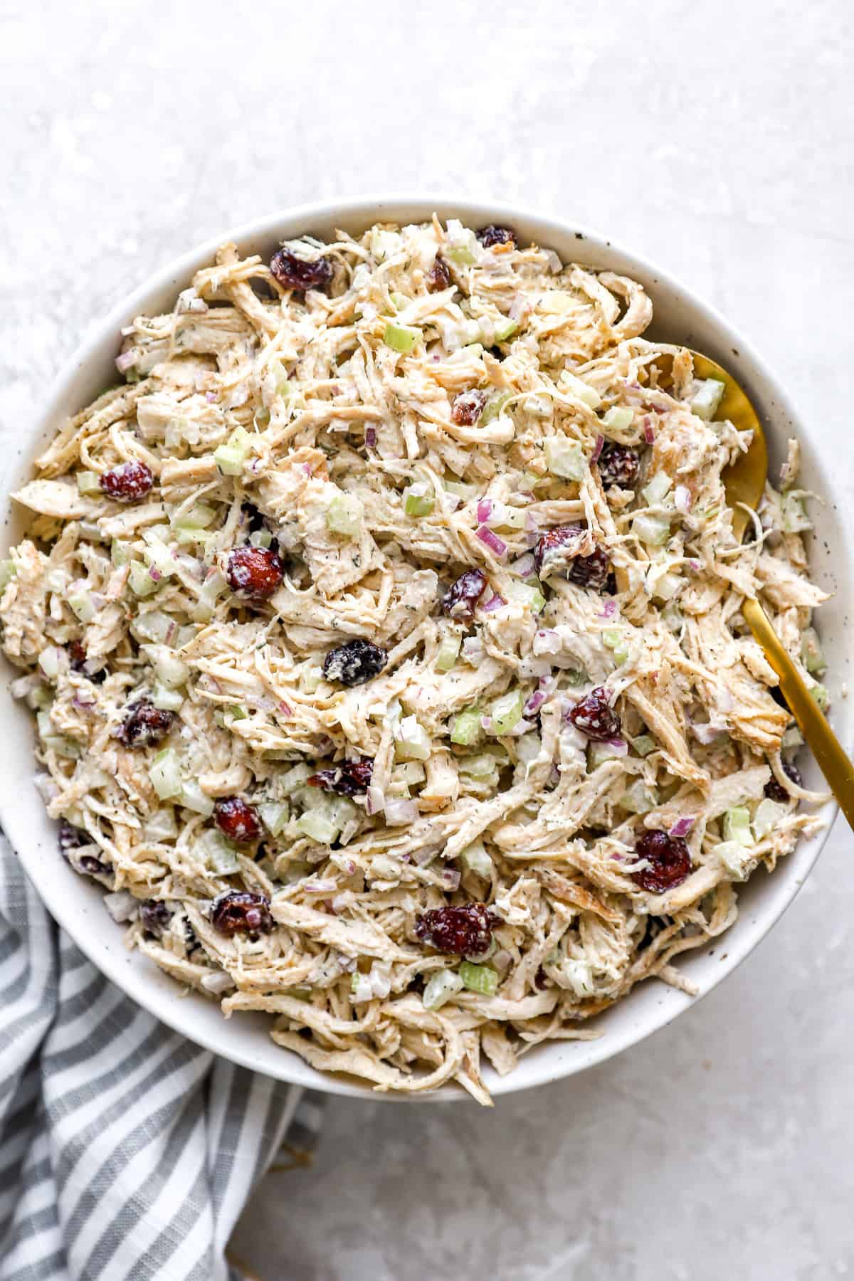 A bowl of classic chicken salad with cranberries.