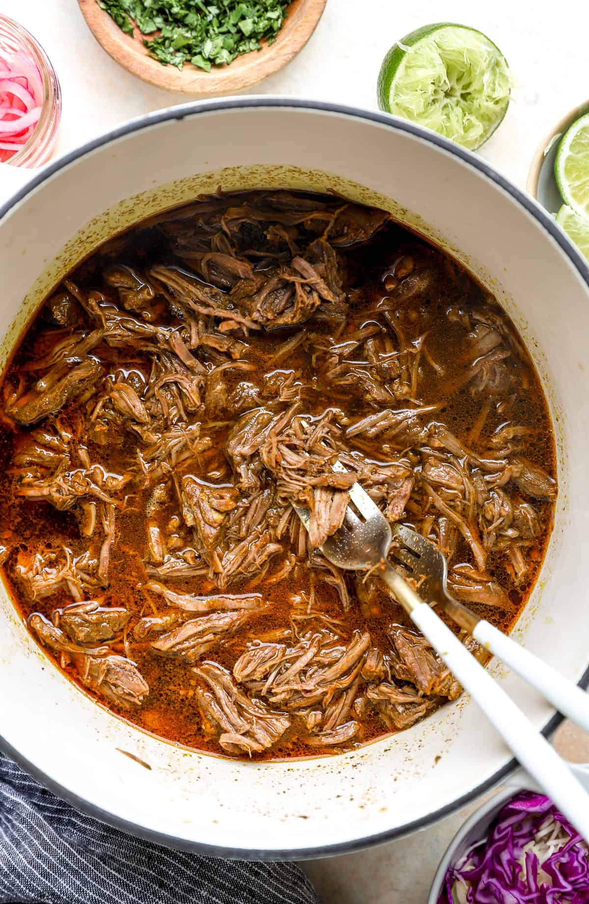 Shredded beef in a Dutch oven.