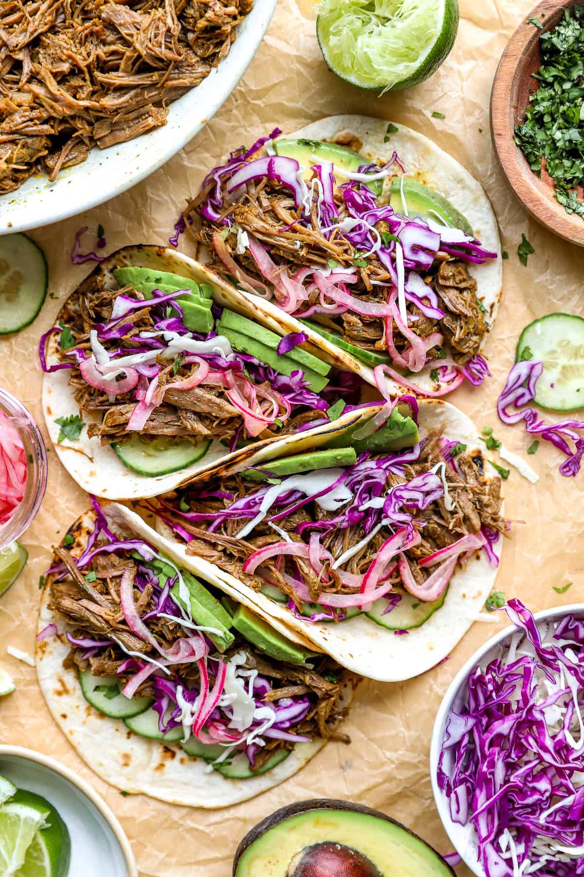 Shredded beef taco with pickled red onions, cabbage, and avocado.