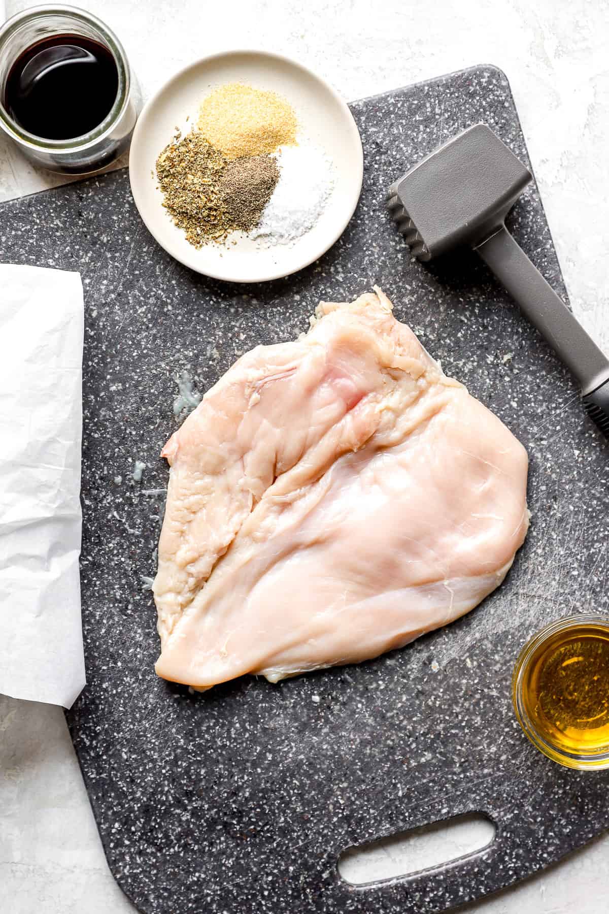 A pounded chicken breast on a cutting board.