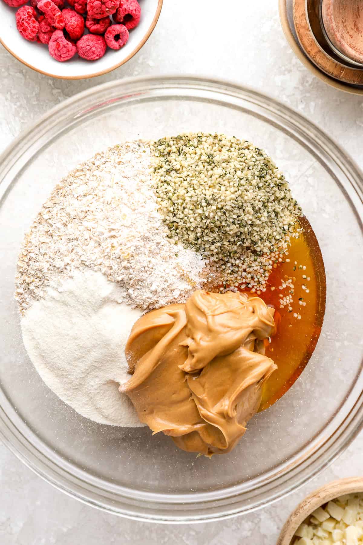 Ingredients to make raspberry white chocolate protein balls in a bowl.
