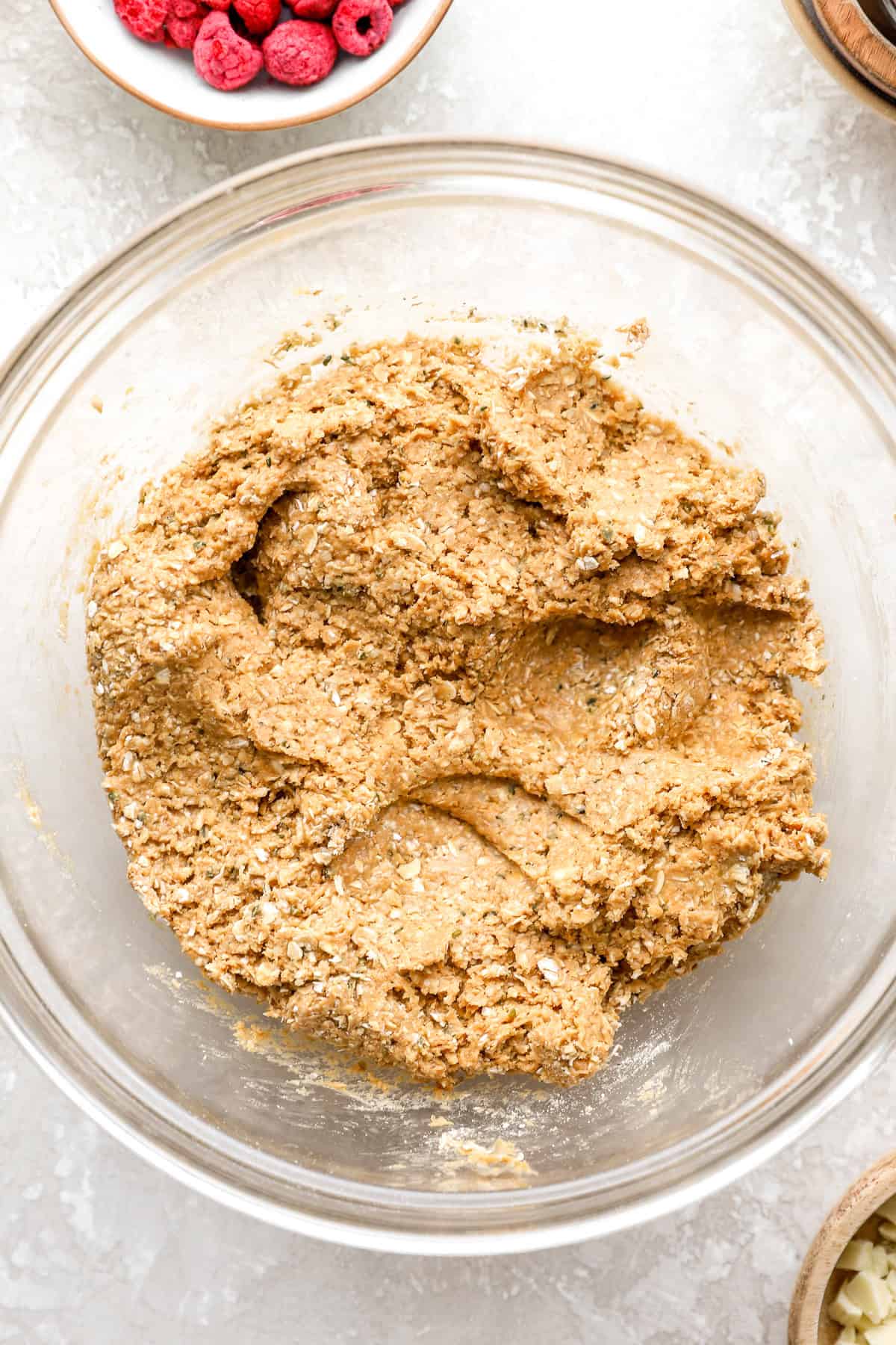 Raspberry white chocolate protein ball dough in a bowl.