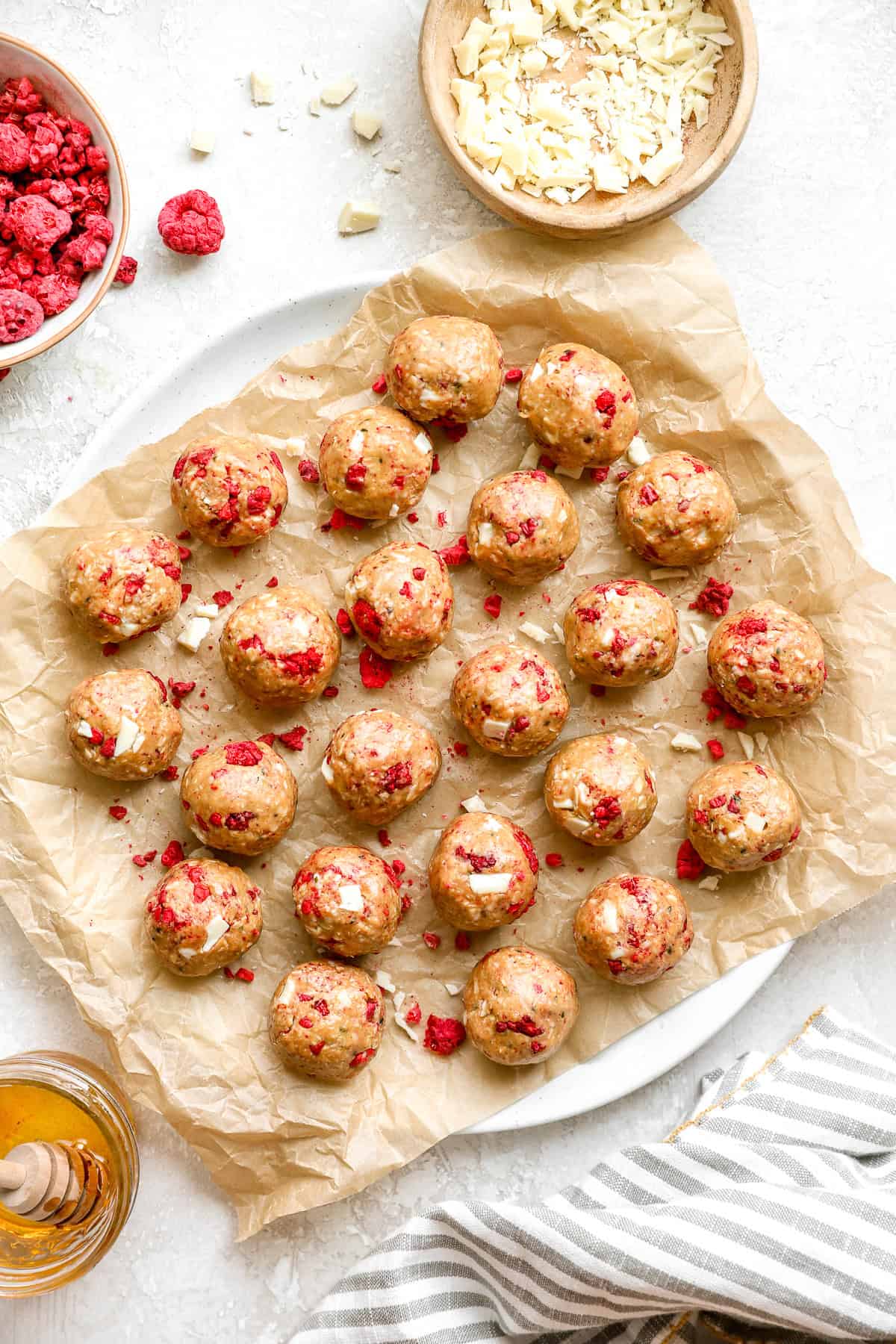 A platter of no-bake raspberry white chocolate protein balls.