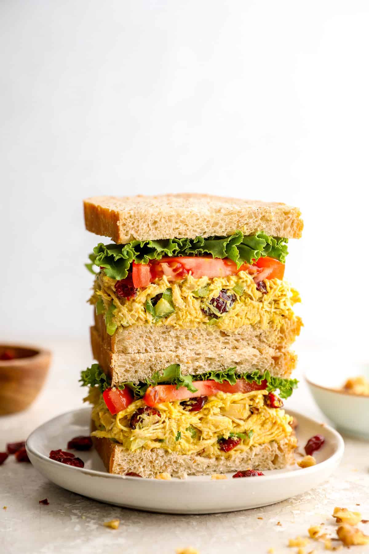Two halves of a curried chicken salad sandwich stacked on top of each other.