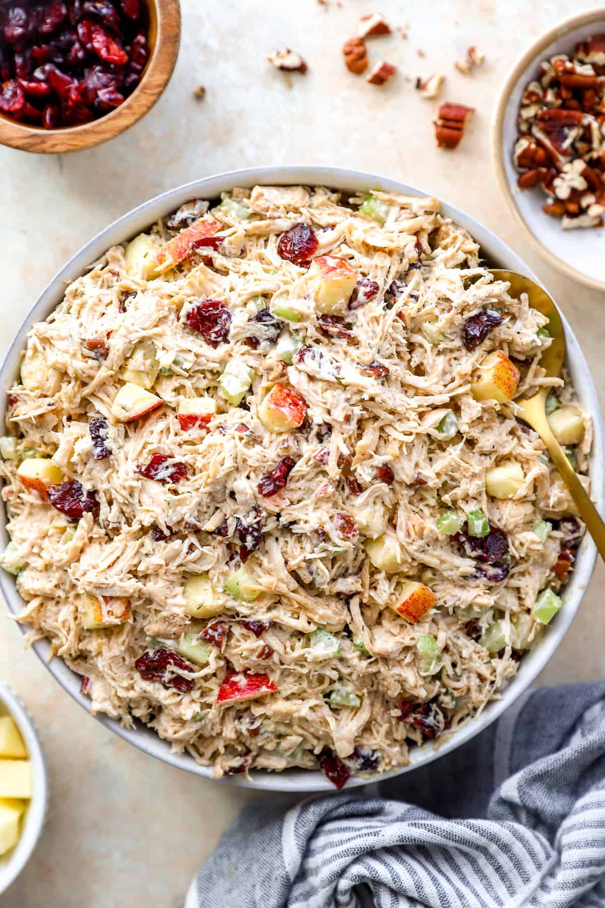 Harvest chicken salad in a bowl, a spoon sticking out.