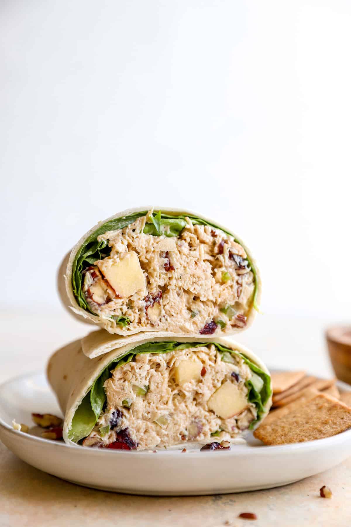Harvest chicken salad in a tortilla wrap, sliced into two halves.
