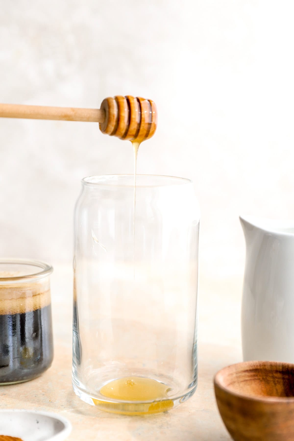 Honey being added to a glass.