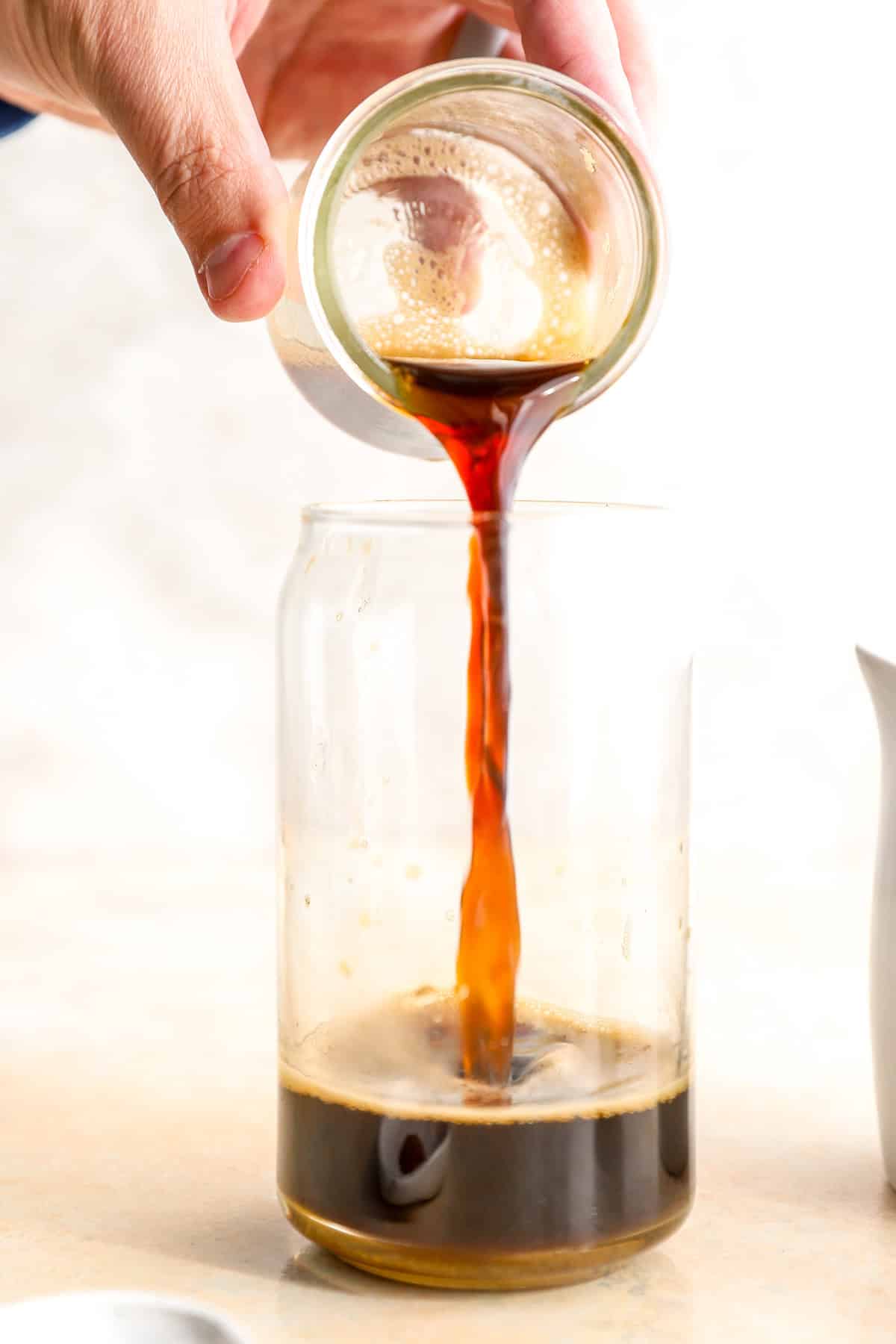 Espresso being poured into a glass.
